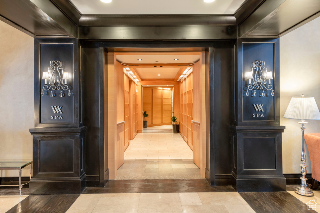 Hall with crown molding, tile patterned floors, and recessed lighting