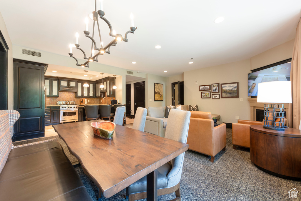 Dining space featuring a chandelier and recessed lighting