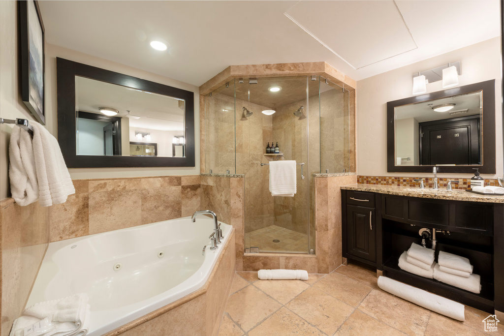 Full bath with a tub with jets, a shower stall, and vanity