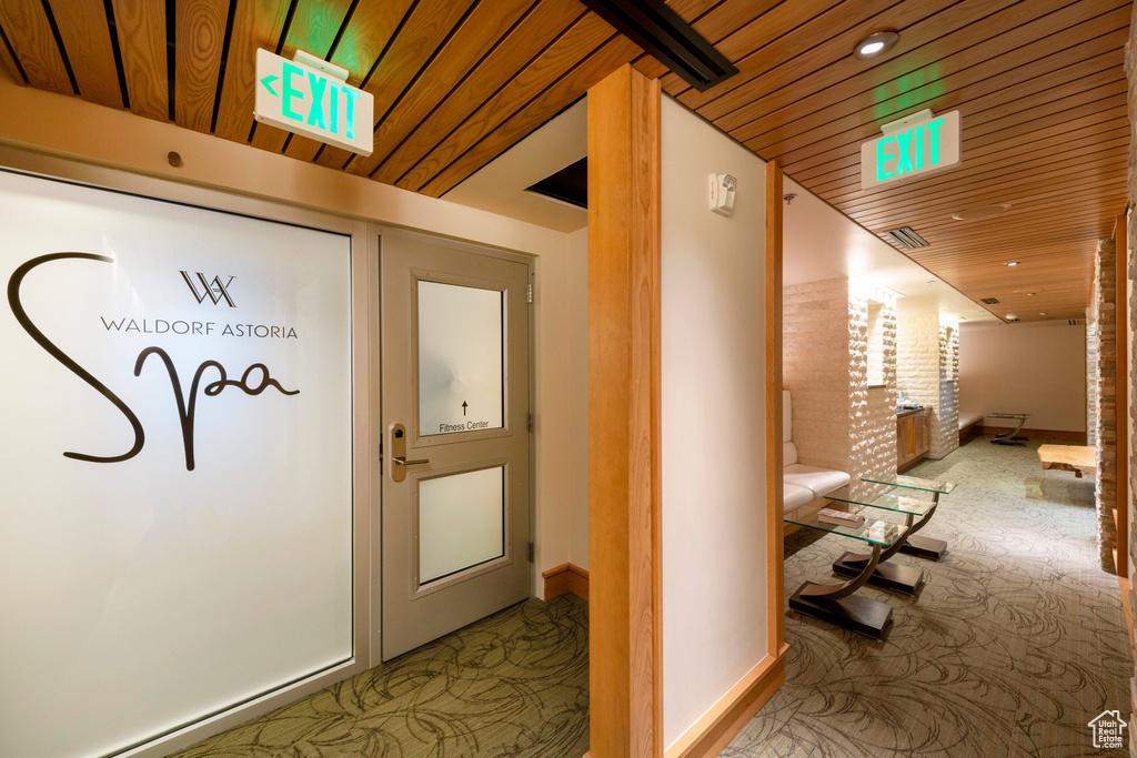 Corridor featuring wooden ceiling and recessed lighting