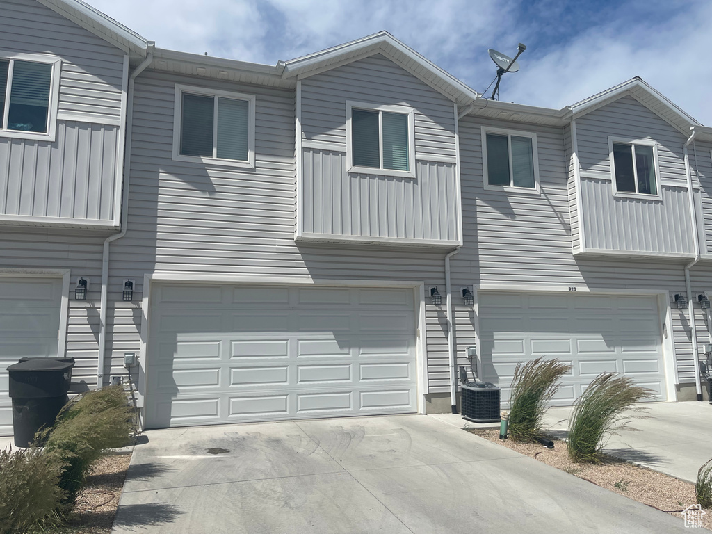 View of front of property with an attached garage and driveway