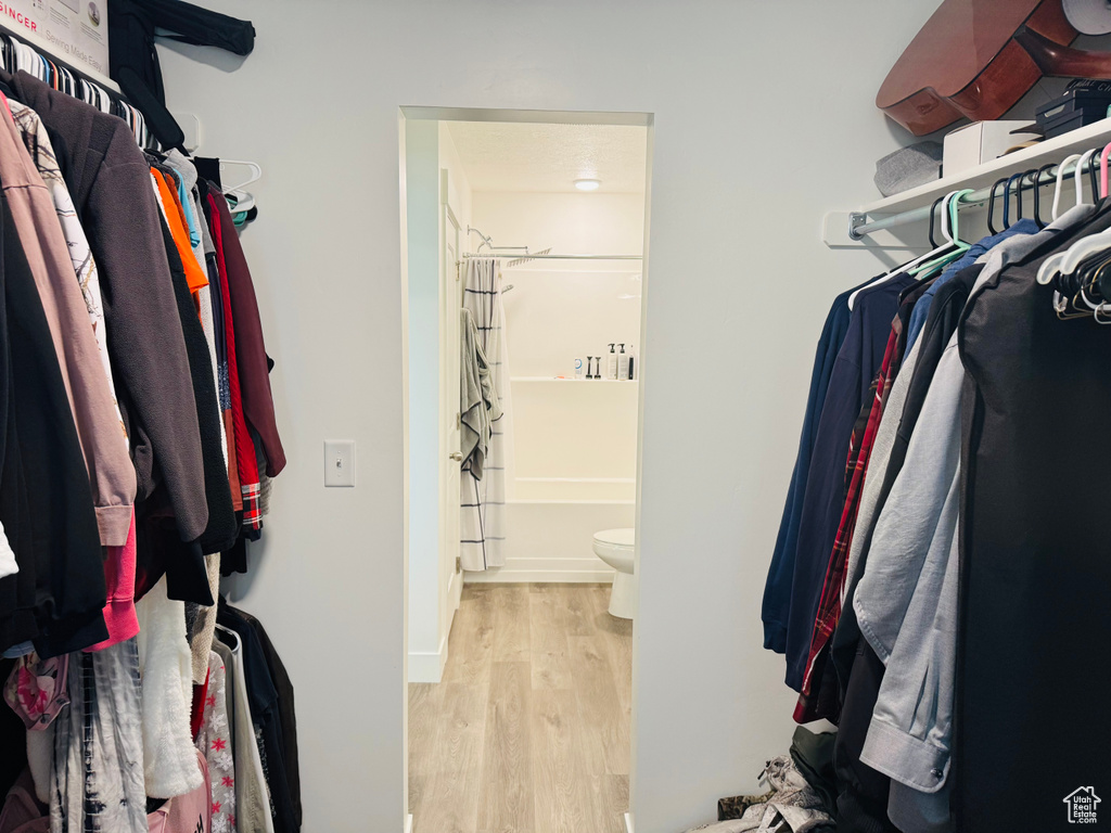Spacious closet with wood finished floors