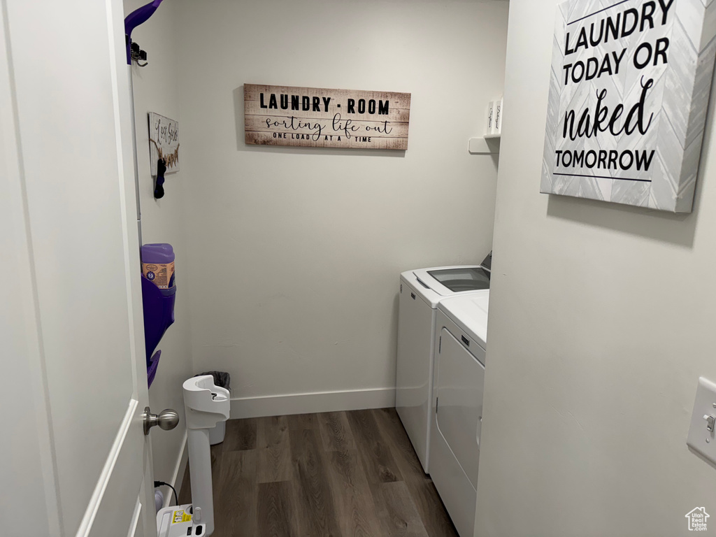 Laundry room featuring separate washer and dryer and dark wood finished floors
