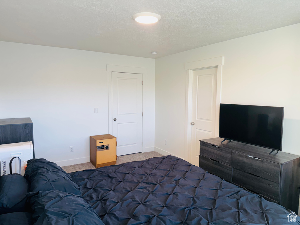 Carpeted bedroom with baseboards