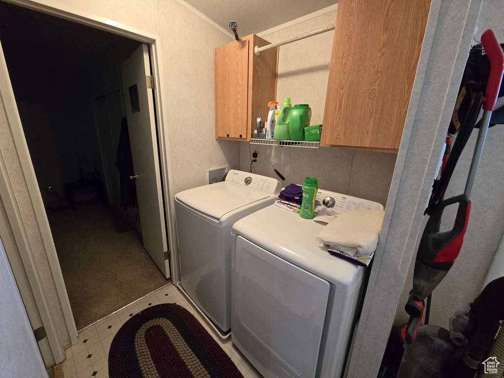 Laundry area featuring washer and dryer and cabinet space