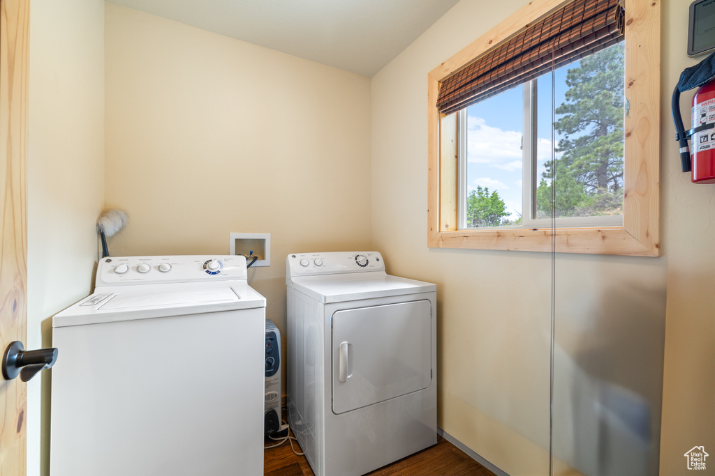 Laundry area featuring separate washer and dryer and dark wood-style floors