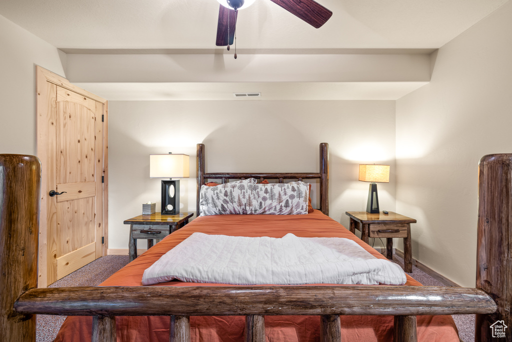 Carpeted bedroom featuring baseboards and a ceiling fan