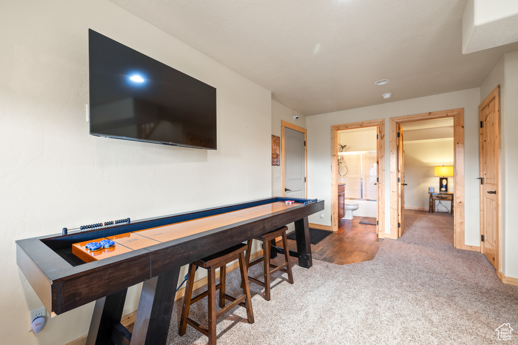 Hallway featuring carpet flooring and baseboards