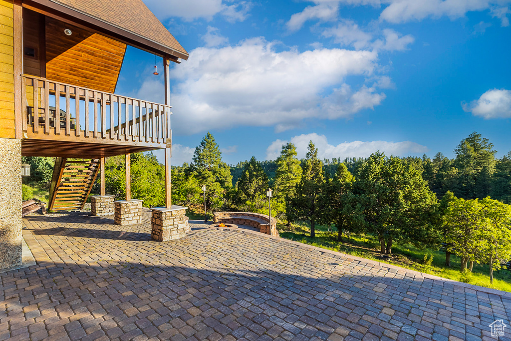 View of patio with stairway and a jacuzzi