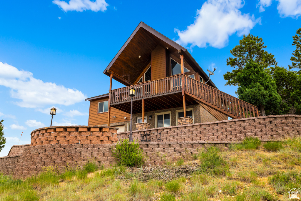 Rear view of property featuring a wooden deck