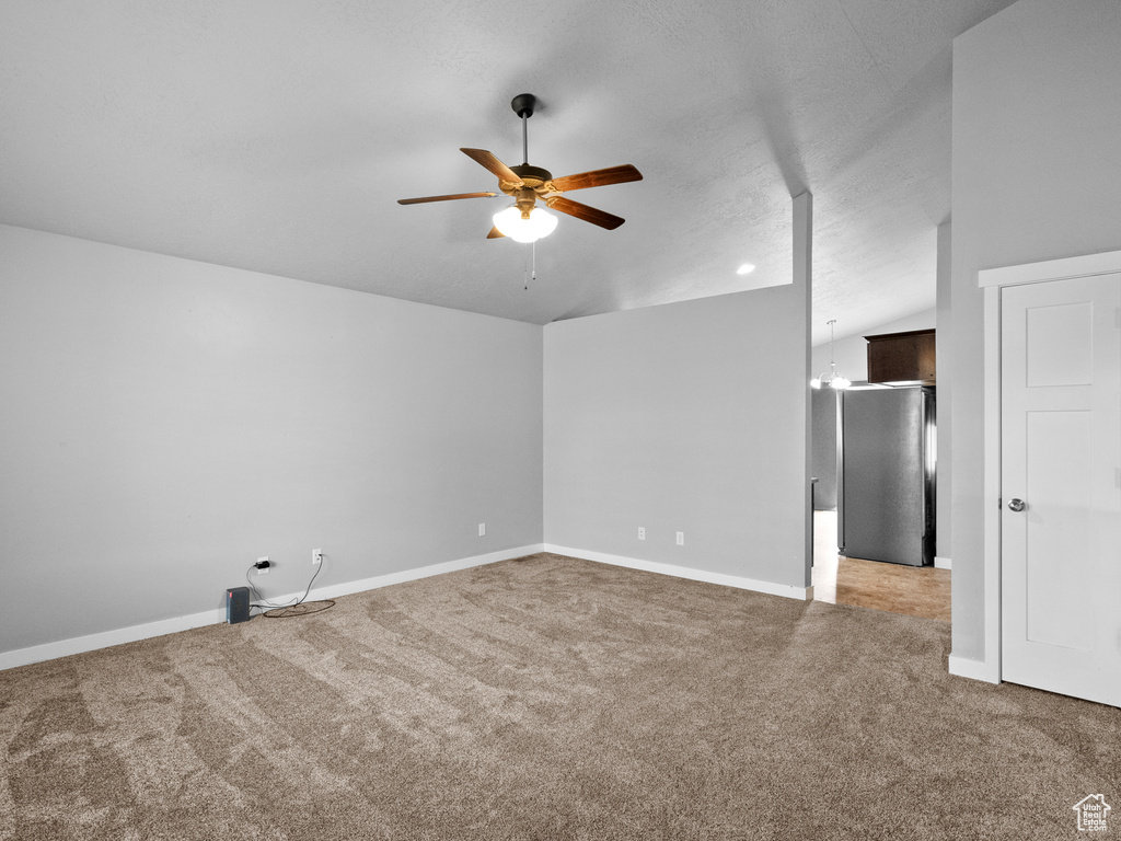 Spare room with carpet floors and a ceiling fan