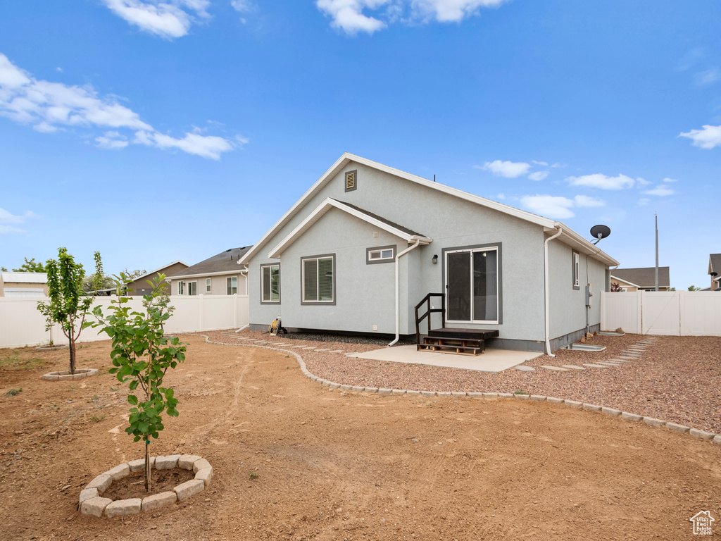 Back of house featuring a fenced backyard and a patio