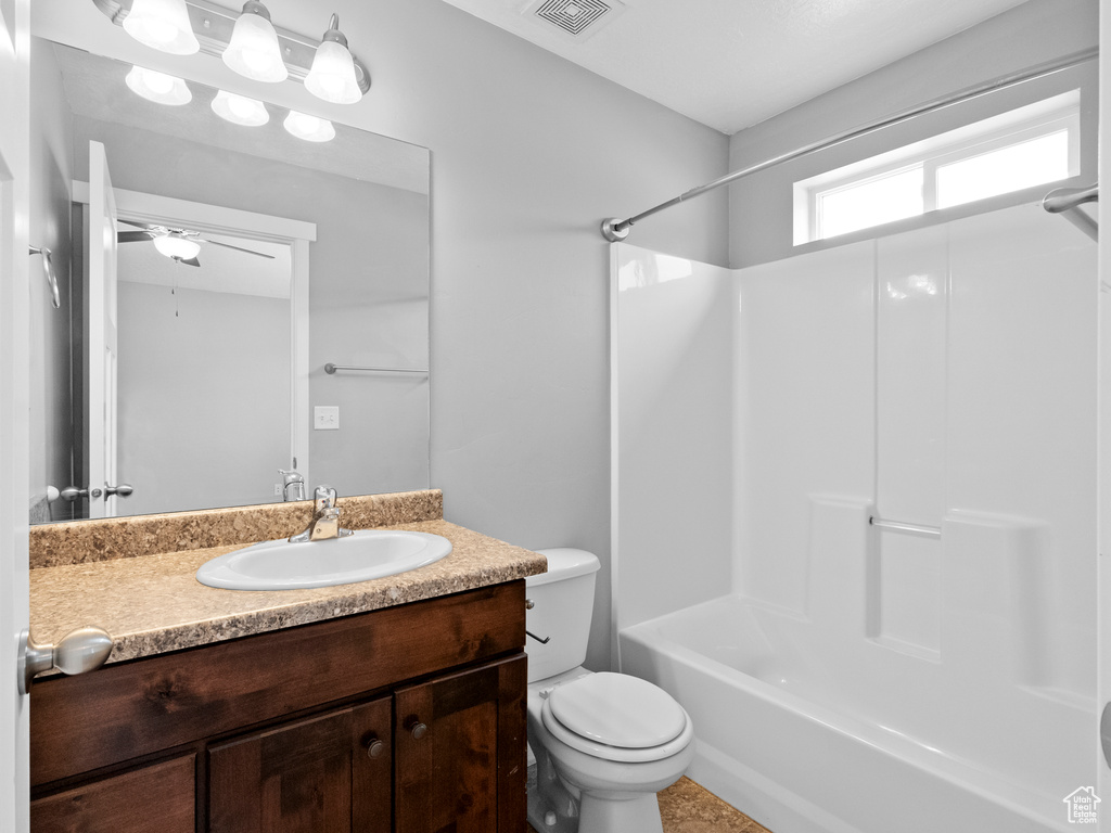 Bathroom with vanity, bathing tub / shower combination, and ceiling fan
