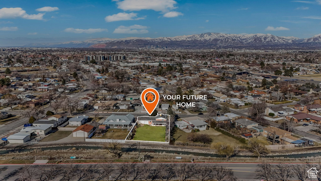 Aerial view of property's location with mountains and nearby suburban area