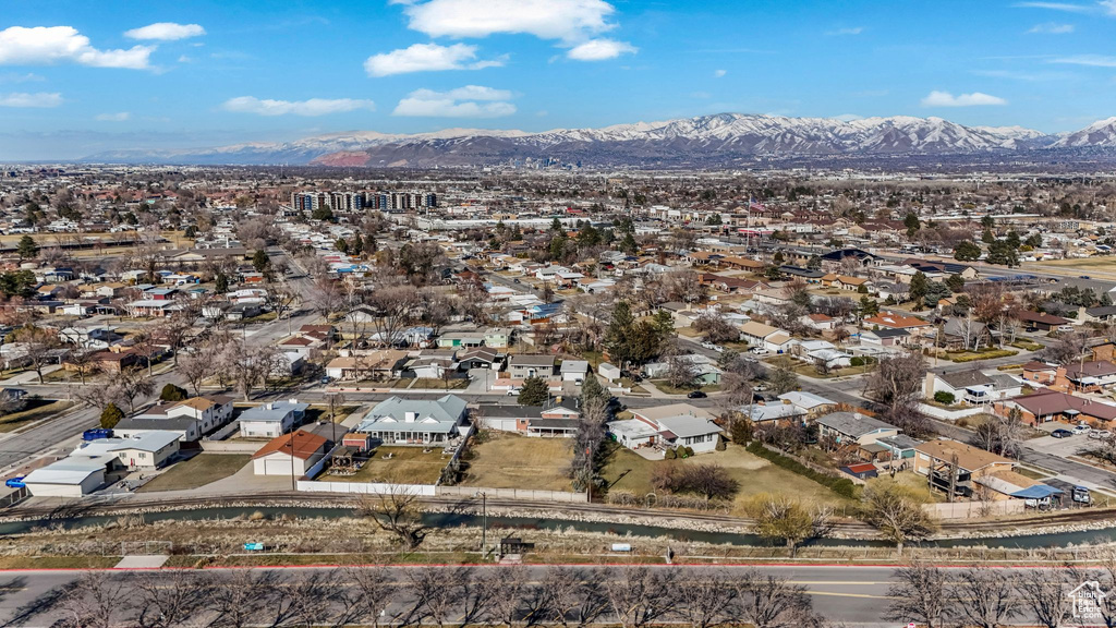 Aerial overview of property's location featuring a mountain backdrop and nearby suburban area