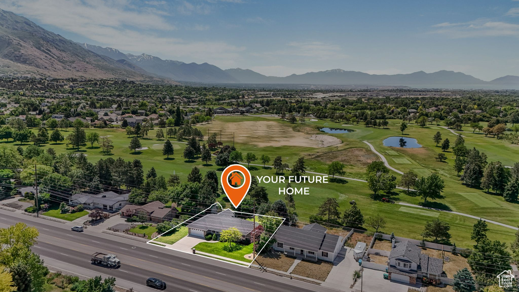 Aerial perspective of suburban area featuring a water and mountain view, property parcel outlined, and a local golf course