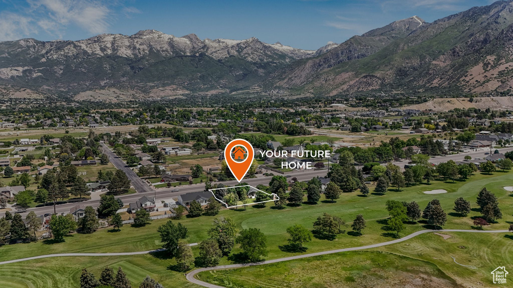 Aerial view of residential area featuring a golf course and mountains