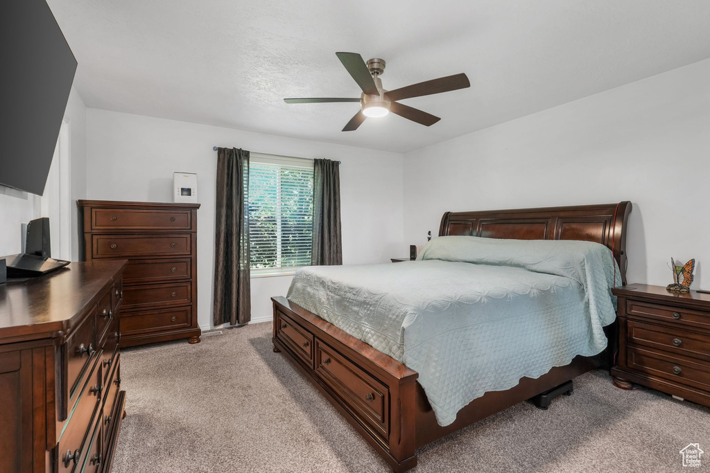Bedroom featuring light colored carpet and a ceiling fan