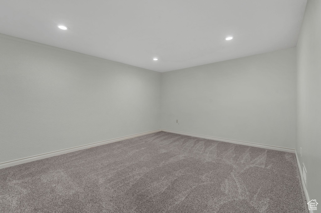 Spare room featuring carpet and recessed lighting