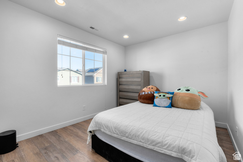Bedroom featuring wood finished floors and recessed lighting