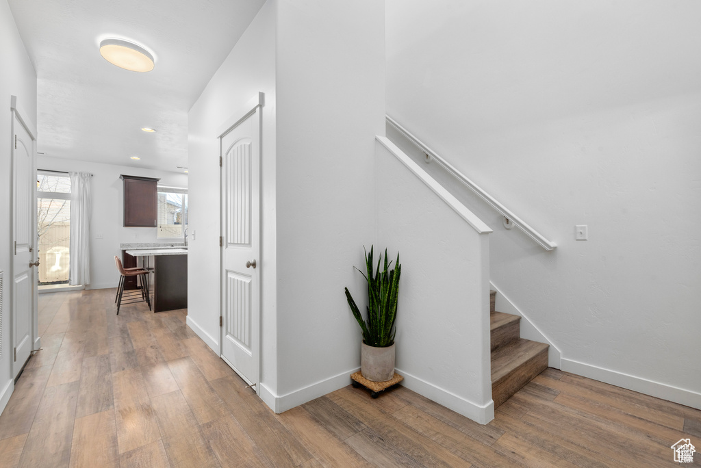 Hallway featuring light wood-style floors and stairway