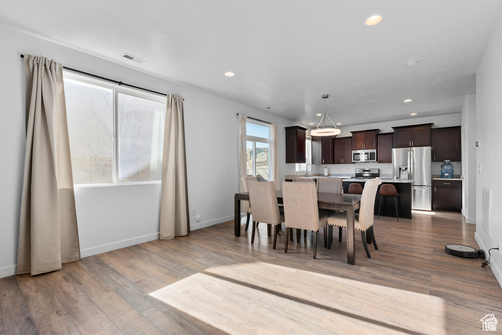 Dining area featuring wood finished floors and recessed lighting