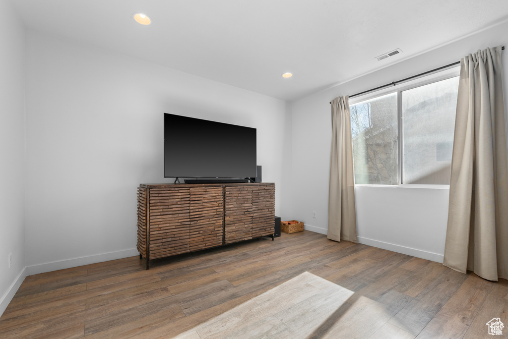 Bedroom featuring wood finished floors and recessed lighting