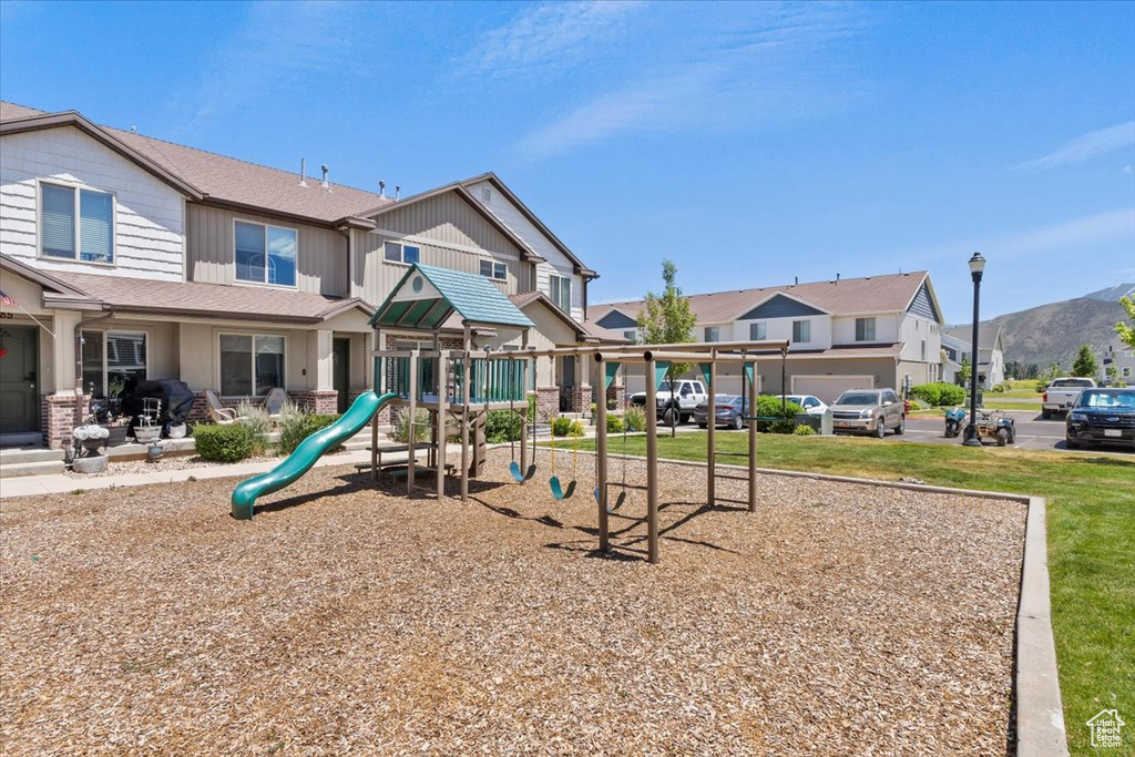 Community jungle gym with a mountain view and a residential view