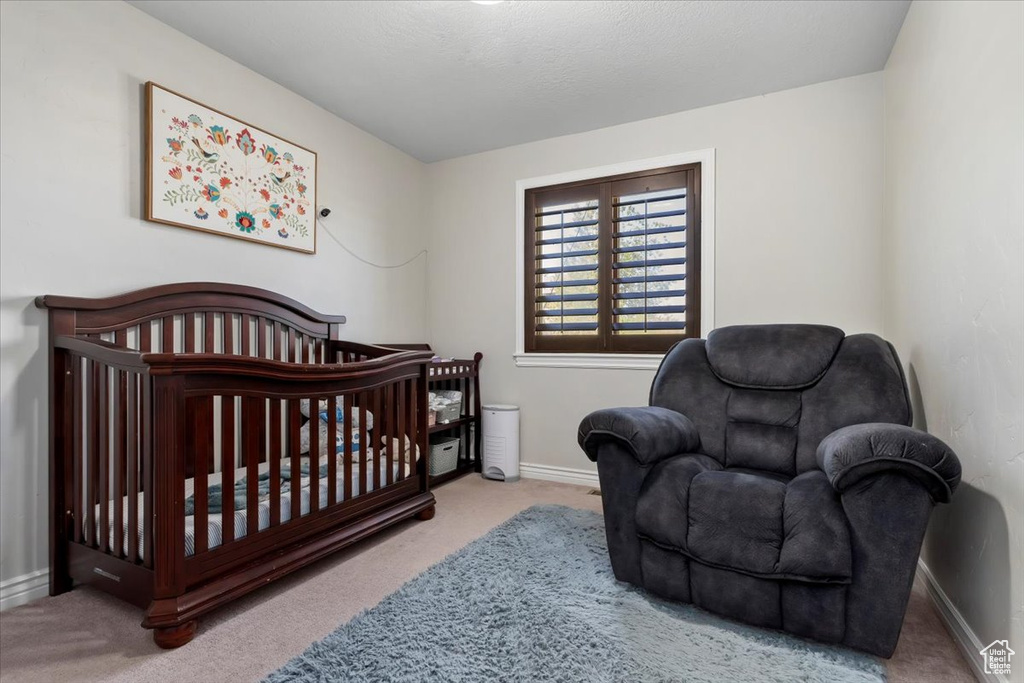Bedroom featuring carpet flooring and baseboards