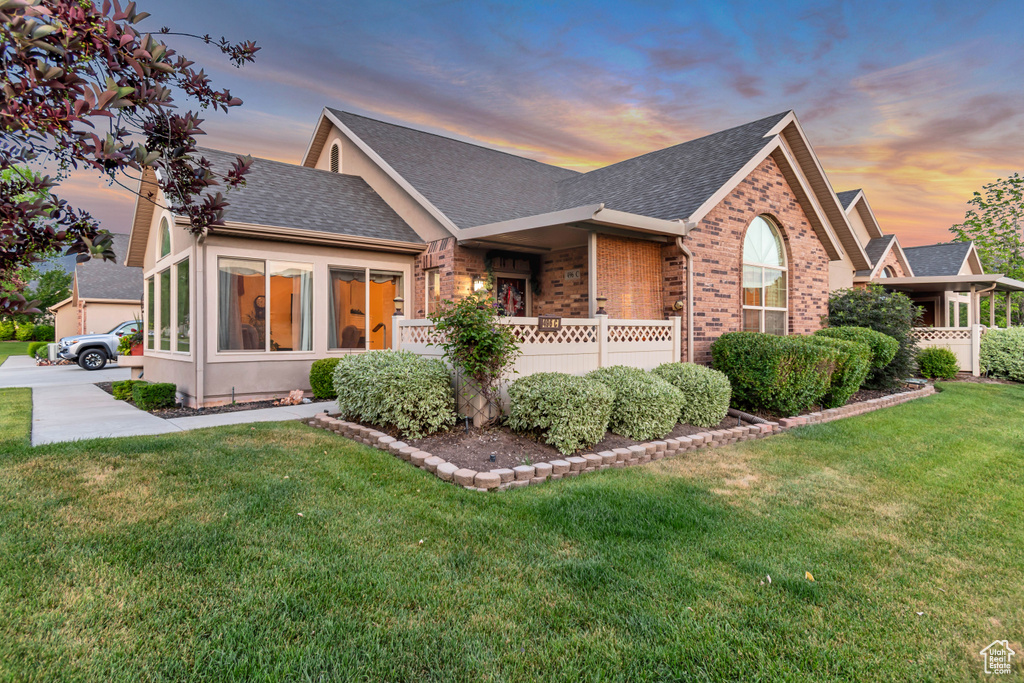 View of front of home with brick siding and a shingled roof