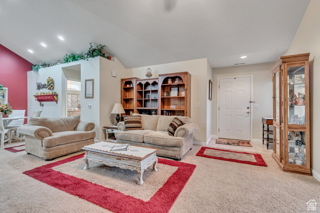 Living area with light carpet, recessed lighting, and lofted ceiling