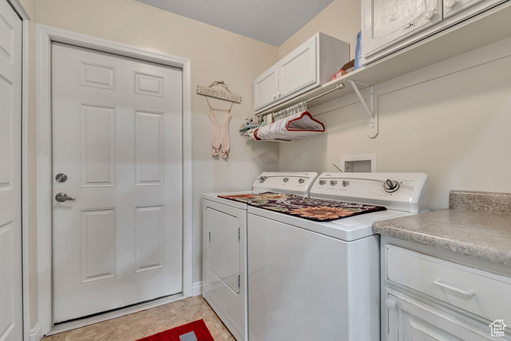 Laundry room with separate washer and dryer and cabinet space