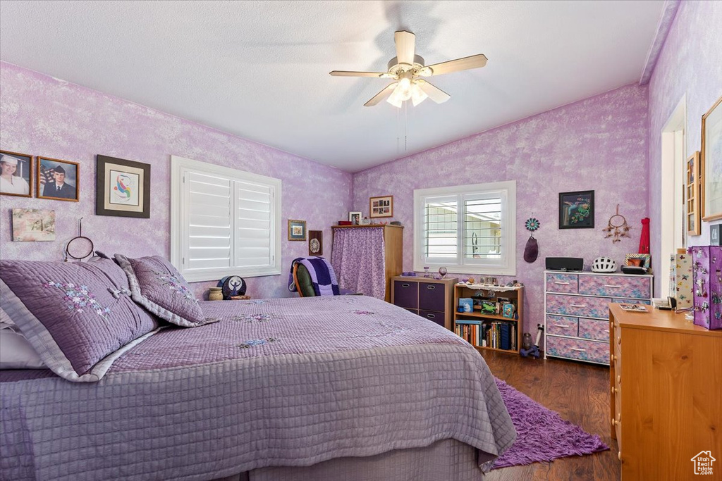 Bedroom featuring wood finished floors, lofted ceiling, and ceiling fan