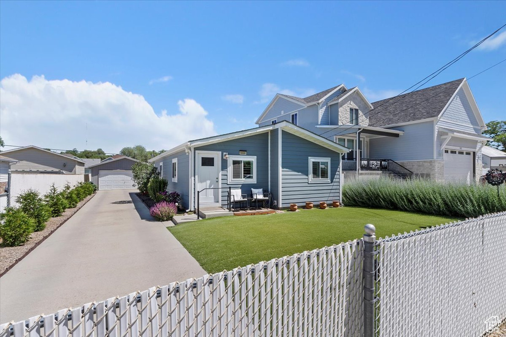 Traditional-style house with a detached garage and an outdoor structure