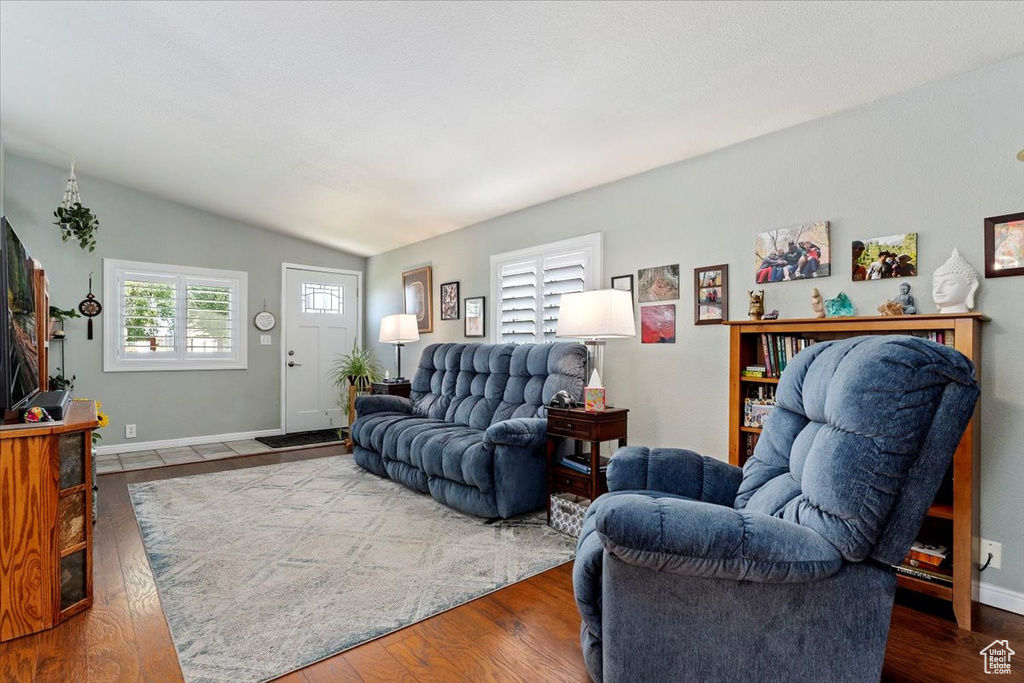 Living area featuring vaulted ceiling and wood finished floors