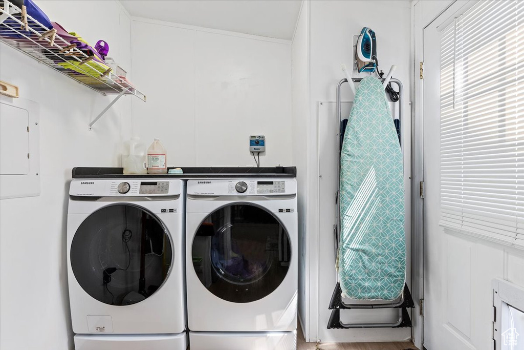 Laundry room with washing machine and dryer and electric panel