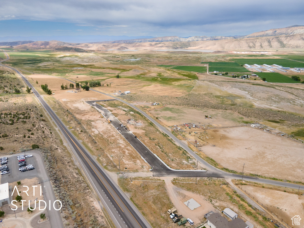 Aerial view of property and surrounding area with a mountain backdrop and rural landscape