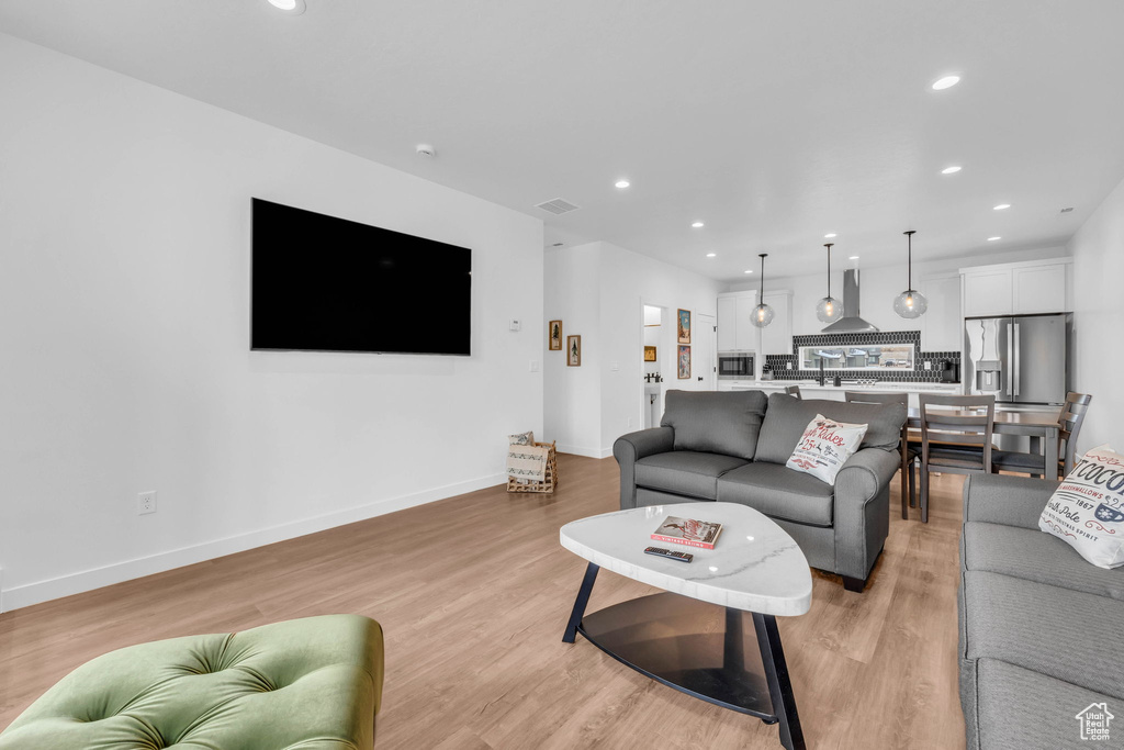 Living room featuring recessed lighting and light wood-type flooring