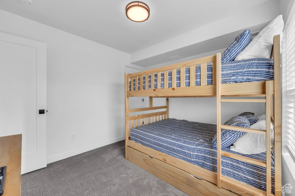 Bedroom with carpet flooring and baseboards