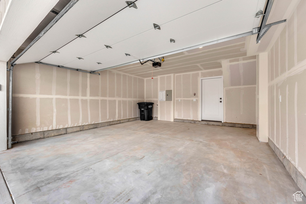 Garage featuring a garage door opener