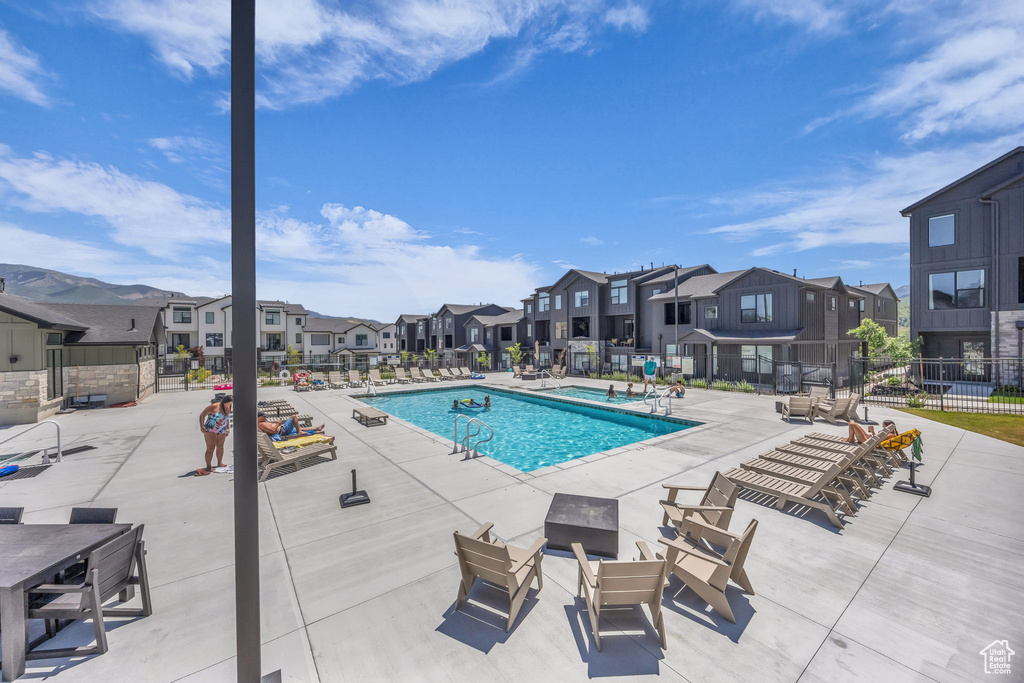 Community pool with a residential view and a patio