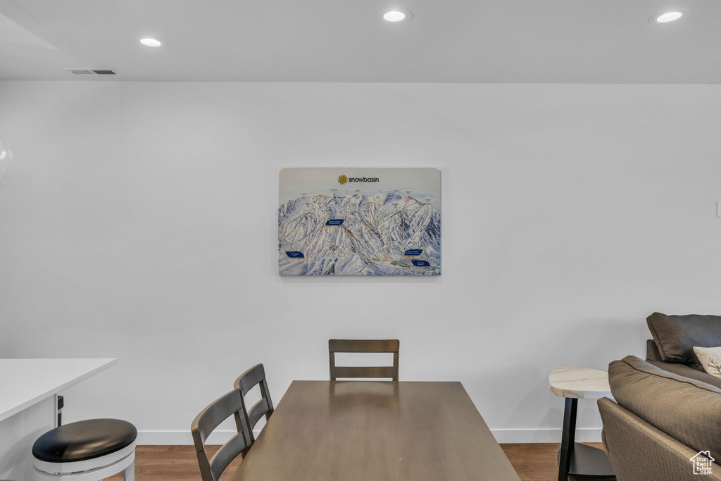Dining space featuring wood finished floors and recessed lighting