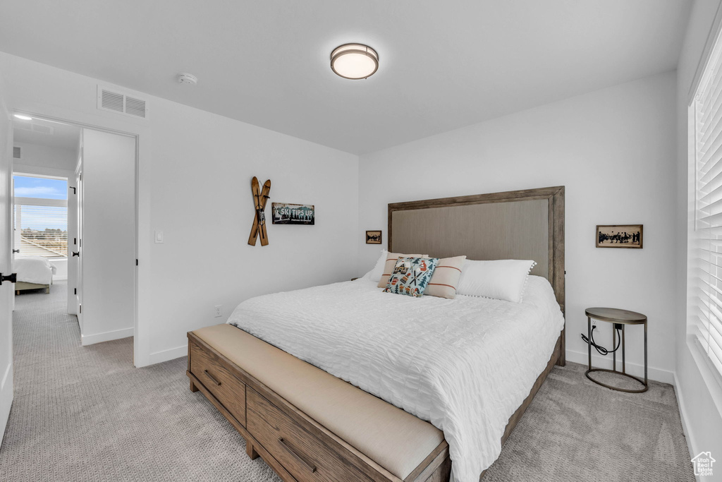 Bedroom with light colored carpet