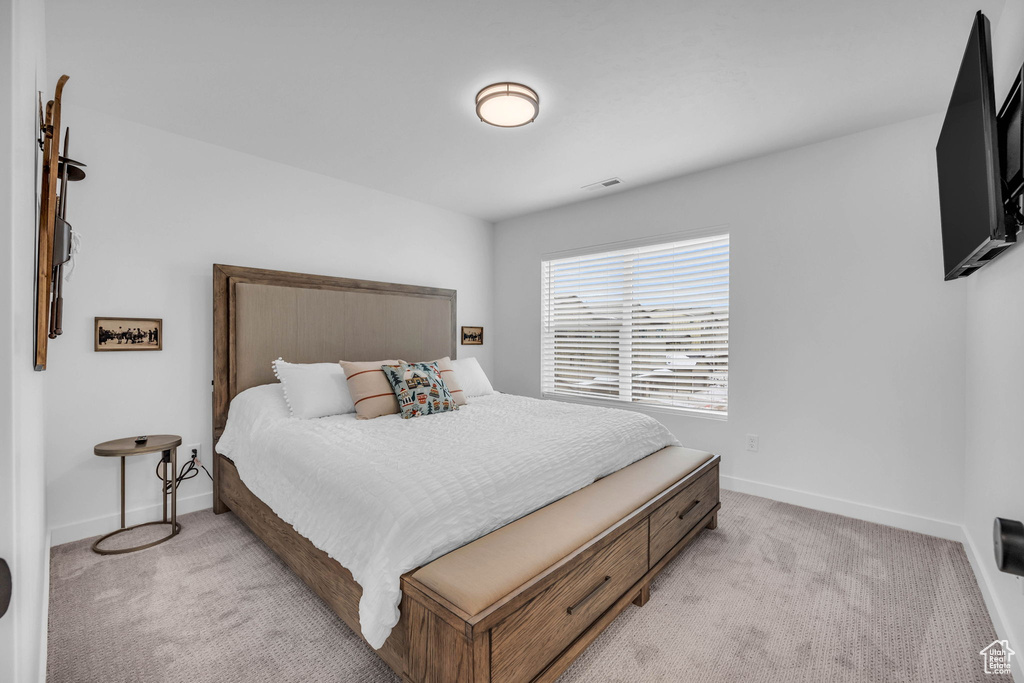 Bedroom with light colored carpet
