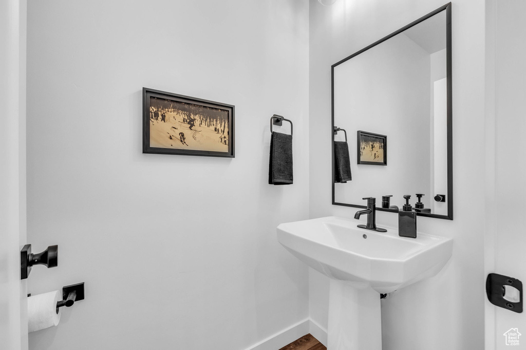 Bathroom with baseboards and wood finished floors