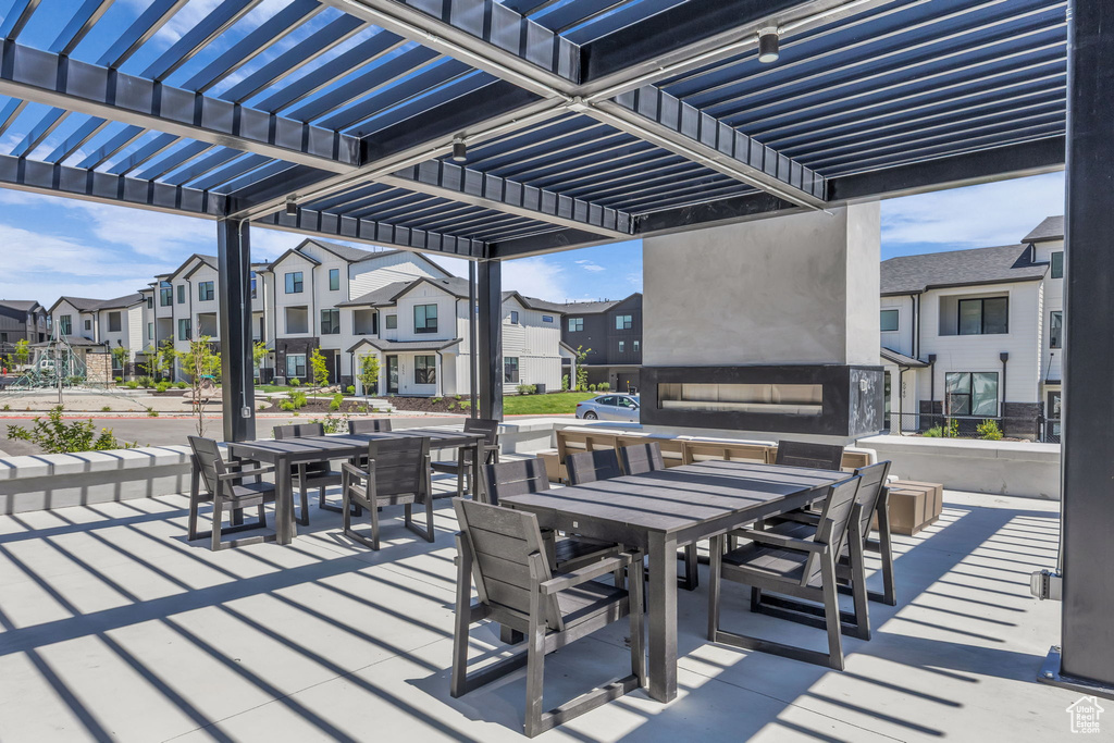 View of patio featuring outdoor dining space, a residential view, and a pergola