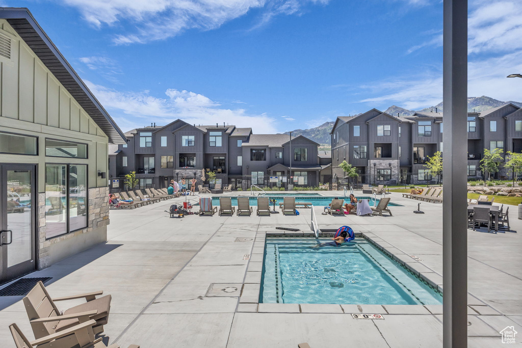 Community pool with a residential view and a patio area