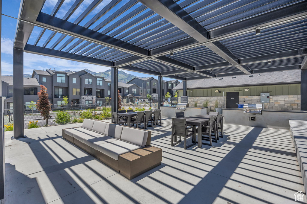 View of patio / terrace with a residential view, outdoor dining space, area for grilling, a pergola, and an outdoor hangout area