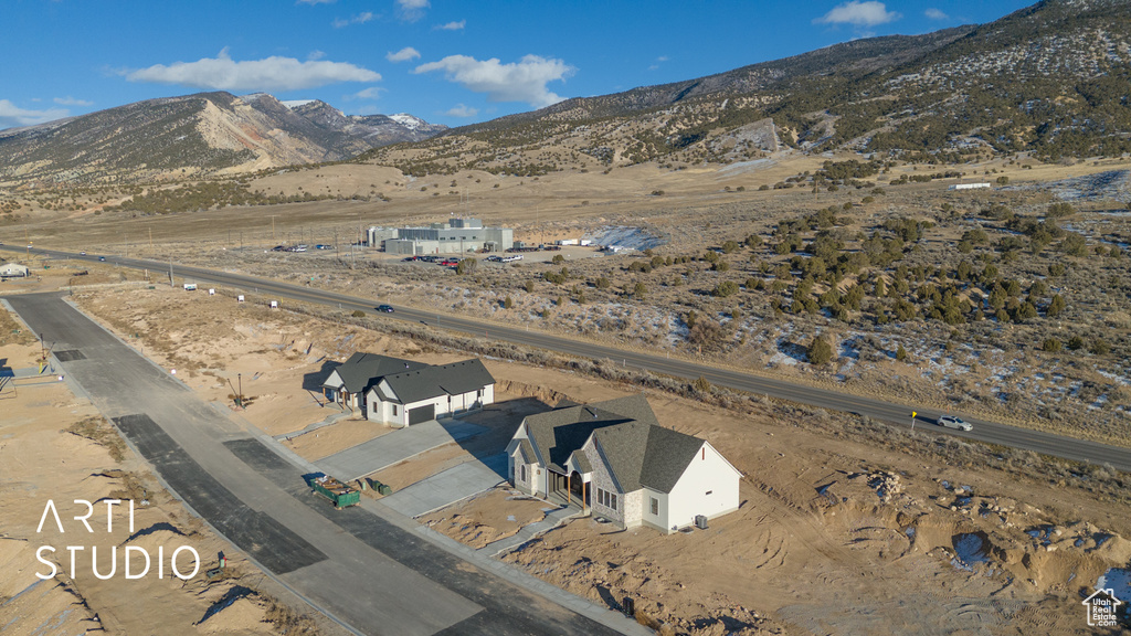 Aerial view of property's location with a mountain backdrop