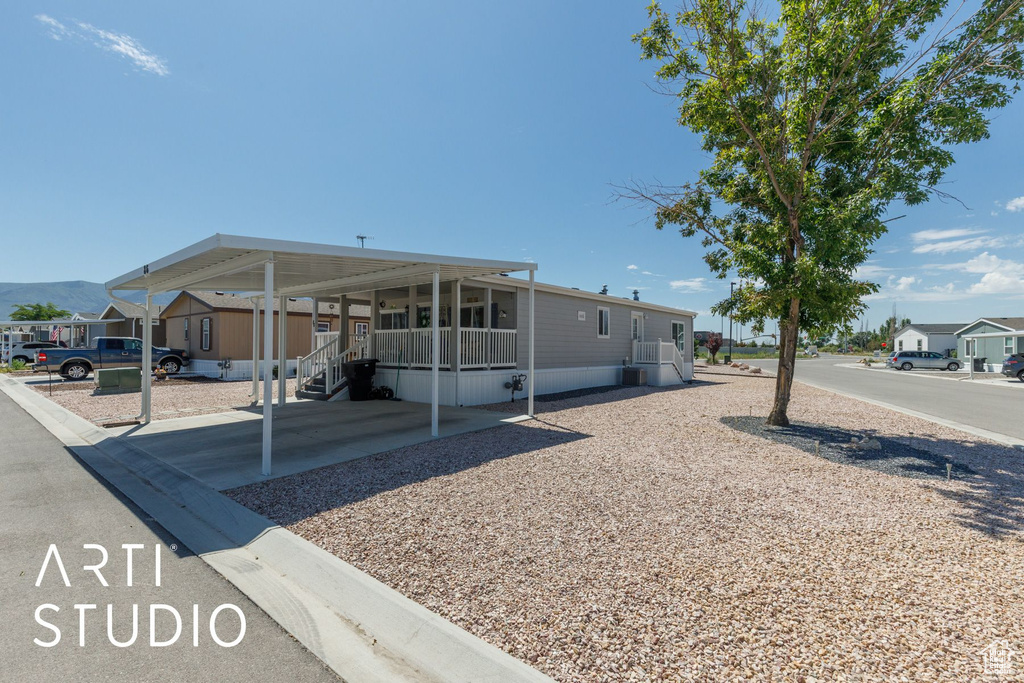 View of side of home with a carport and a mountain view